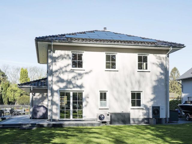 Lugana Rangsdorf von Bau- GmbH Roth - Aussenansicht auf PV-Anlage und Wärmepumpe sowie seitlich auf die Terrasse