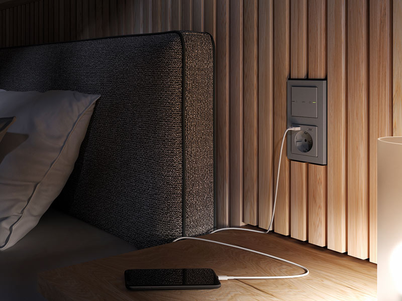 Schalter und Steckdosen in Kombination inklusive USB Ladebuchse neben einem Bett