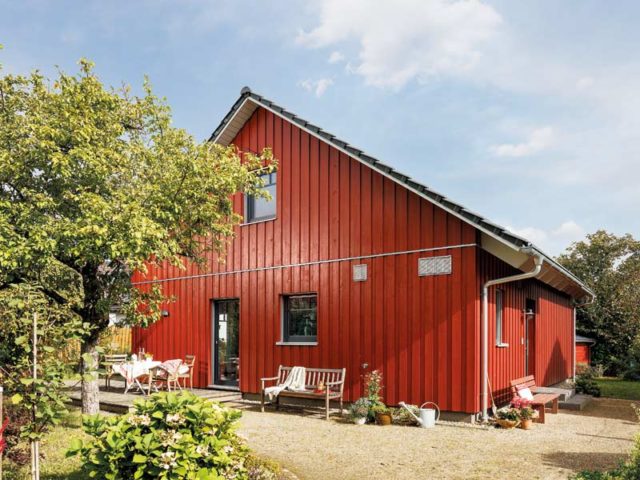 Schwörer Aktionshaus Bungalow mit roter Holzverkleidung und Satteldach für Spitzboden