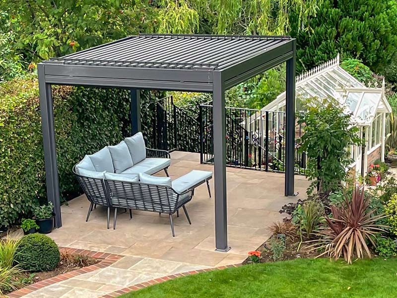 Pergolux Pergola S2 ohne Seitenwände im Garten stehend mit Eckcouch darunter